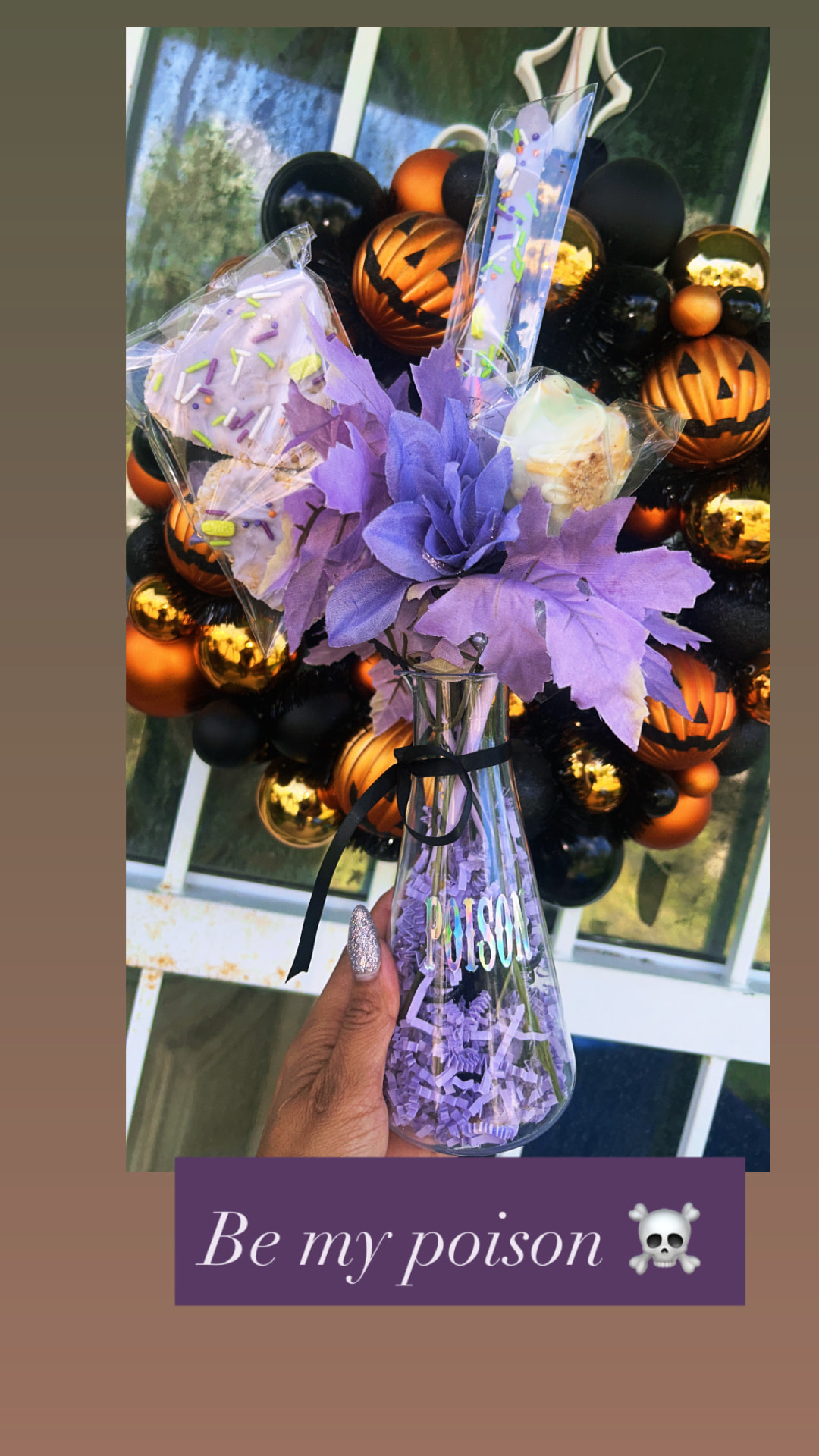 Purple boo basket bouquet with wrapped treats in a poison vase