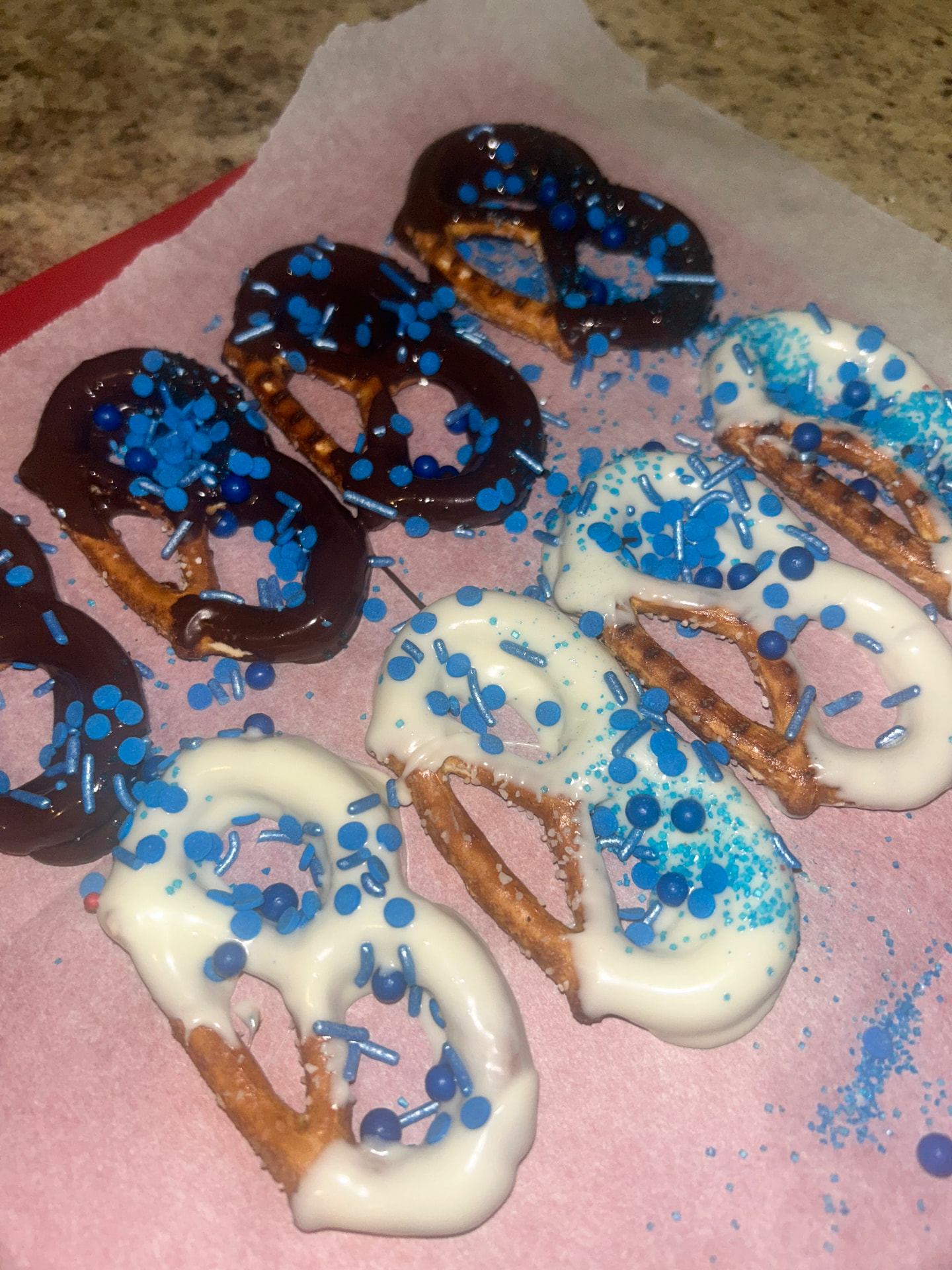 Dark and white chocolate pretzels with blue sprinkles